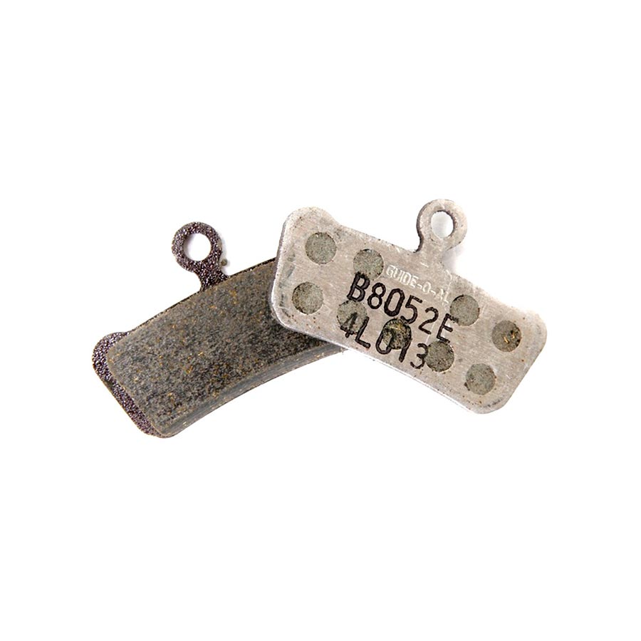 Set of 20 SRAM disc brake pads with metallic backing plates, arranged in a row for bicycle or motorcycle braking system.