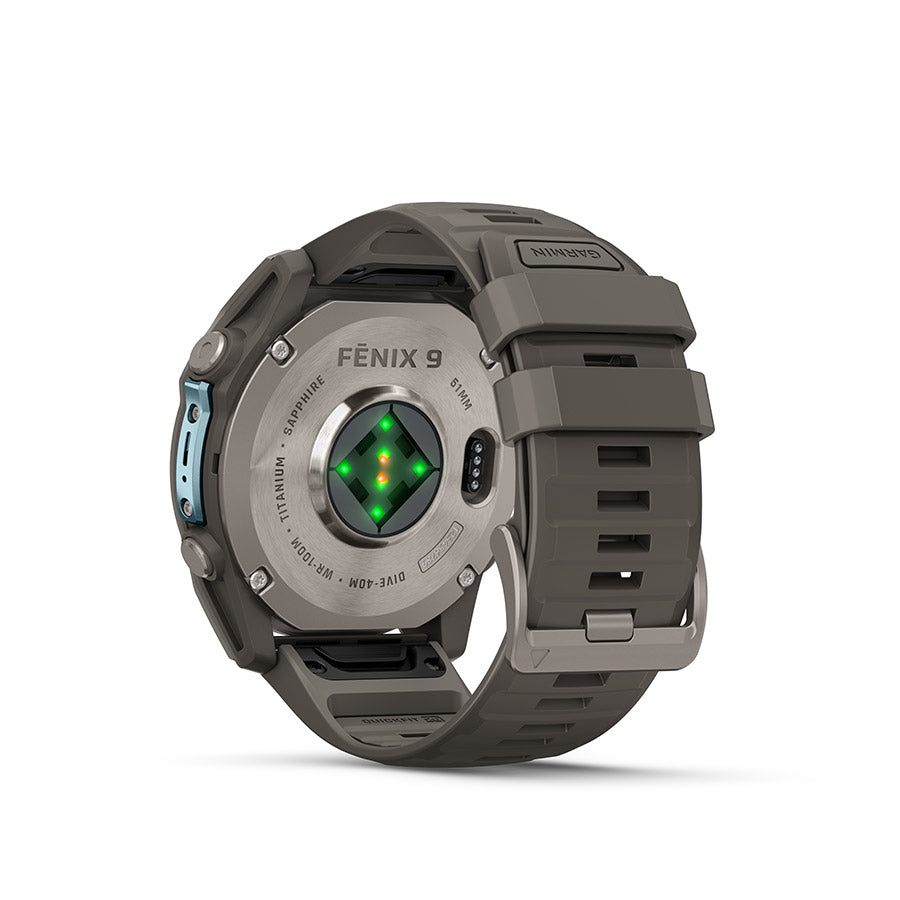 Garmin Fenix 9 51mm cycling computer with GPS display and outdoor functionality, shown on a wrist with cycling gear.