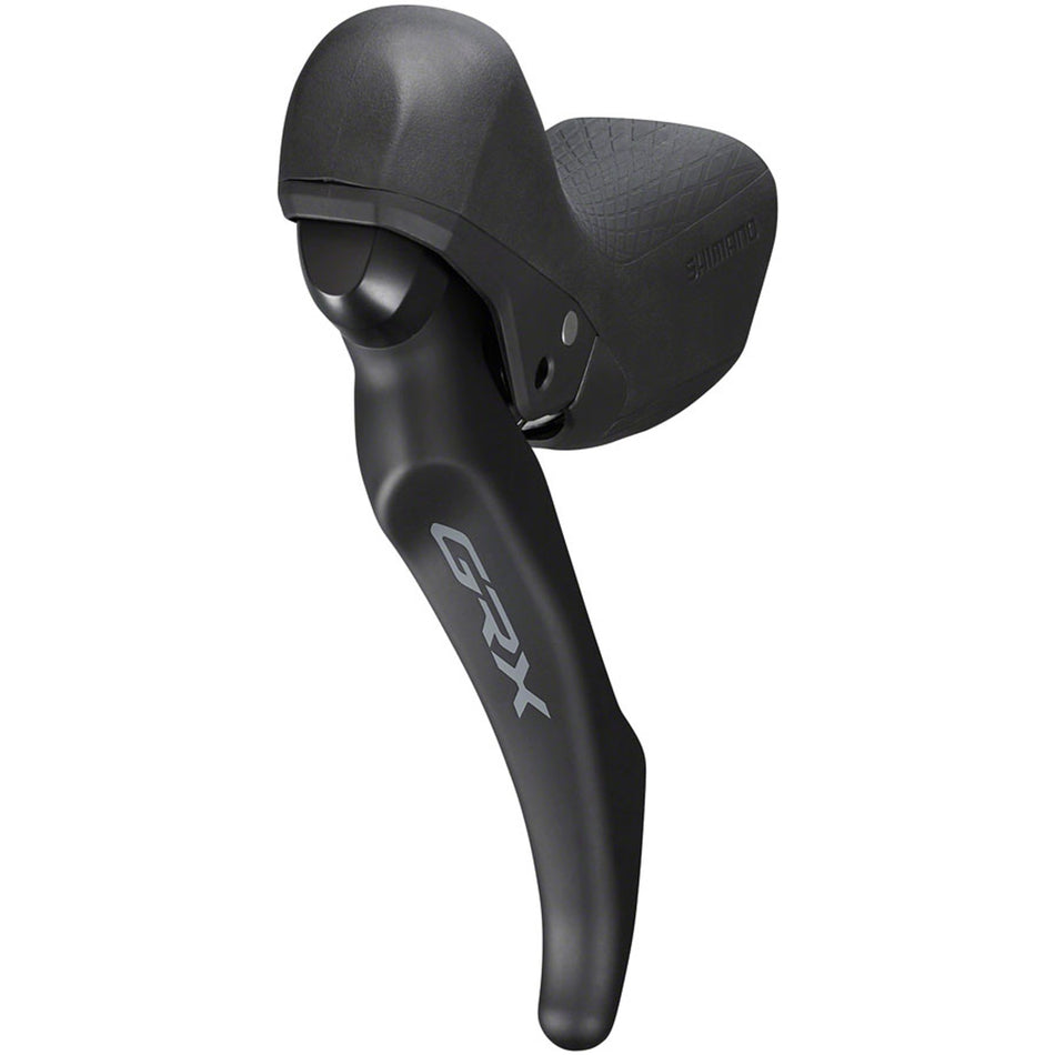 Shimano GRX BL-RX600 hydraulic brake lever for mountain bike, showing ergonomic design and hydraulic mechanism in natural setting.