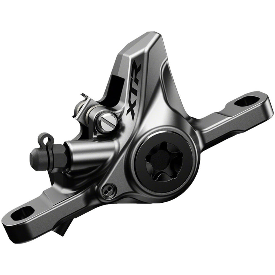 Shimano XTR M9100 brake caliper with mono-body design and ceramic pistons for high-performance mountain bike stopping power.