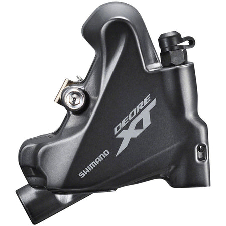 Shimano Deore XT BR-M8100 disc brake calipers mounted on a mountain bike frame, showcasing hydraulic brake components.