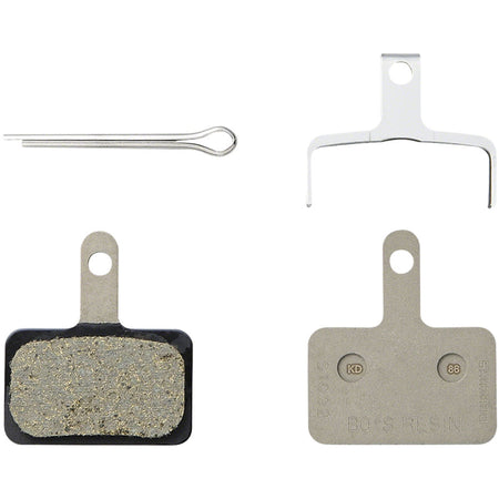 Shimano B05S disc brake pads showing black friction material and metal backing plate for bicycle braking systems.