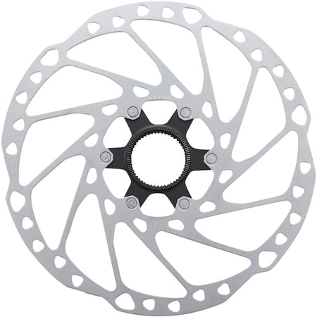 Shimano SM-RT64 disc brake rotor showing vented metal surface and mounting holes for bicycle brake system.