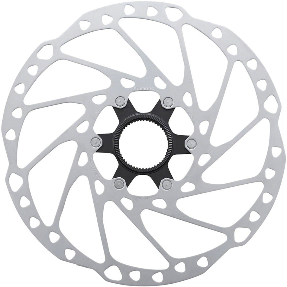 Shimano SM-RT64 disc brake rotor showing vented metal surface and mounting holes for bicycle brake system.