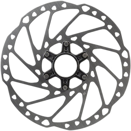 Shimano SM-RT64 disc brake rotor showing vented metal surface and mounting holes for mountain bike braking system.