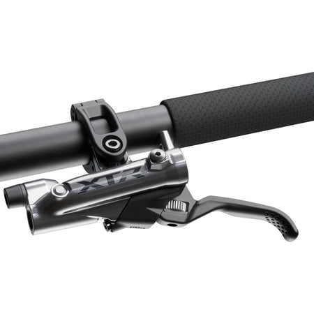 Shimano XTR BR-M9200 disc brake with BL-M9220 lever shown on a mountain bike for reliable stopping power.