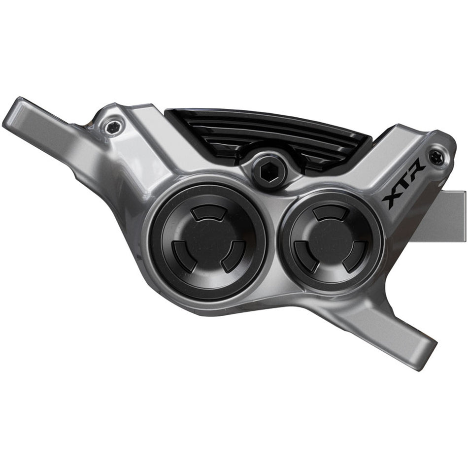 Shimano XTR BR-M9220 Enduro disc brake caliper mounted on mountain bike with hydraulic hoses and mounting hardware.