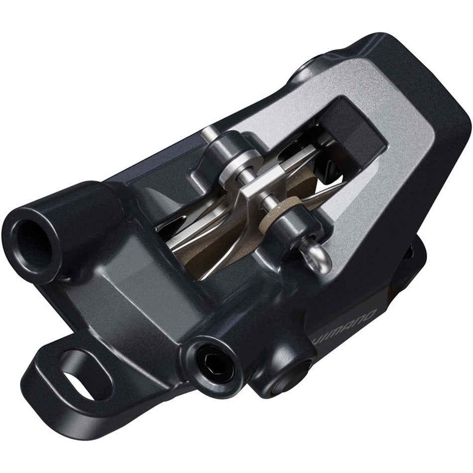 Shimano Deore BR-MT600 disc brake caliper mounted on bike, showing its black metal construction and hydraulic brake components.