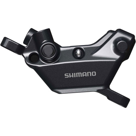 Shimano Deore BR-MT620 disc brake caliper mounted on a bicycle, showcasing the hydraulic brake caliper design.