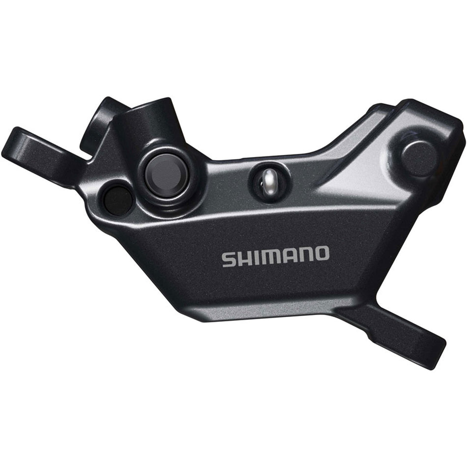 Shimano Deore BR-MT620 disc brake caliper mounted on a bicycle, showcasing the hydraulic brake caliper design.