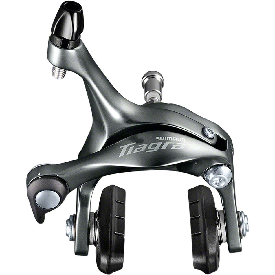 Shimano Tiagra BR-4700 rim brake calipers mounted on a road bicycle, showing sleek silver design and brake pads.