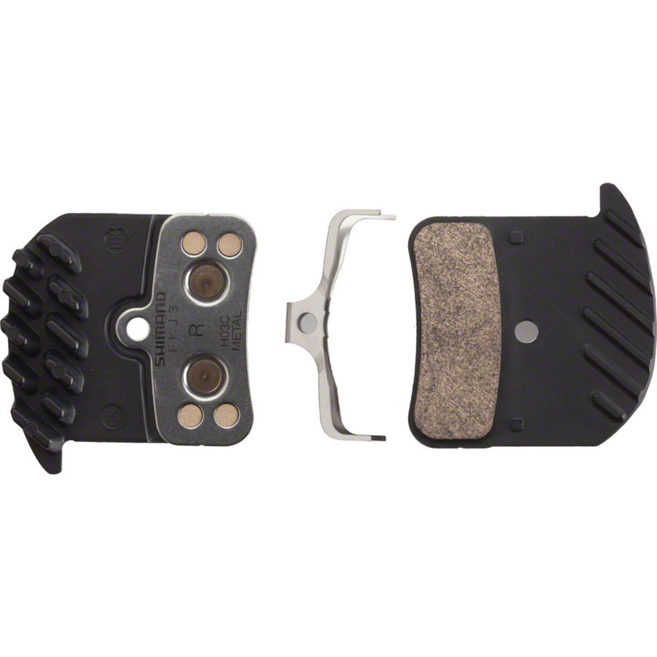 Shimano H03C metal disc brake pads for bicycles, showing the brake pad design and metallic components.