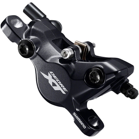 Shimano Deore XT M8100 disc brake mounted on a bicycle wheel with brake rotor and caliper, showcasing high-performance disc braking system.