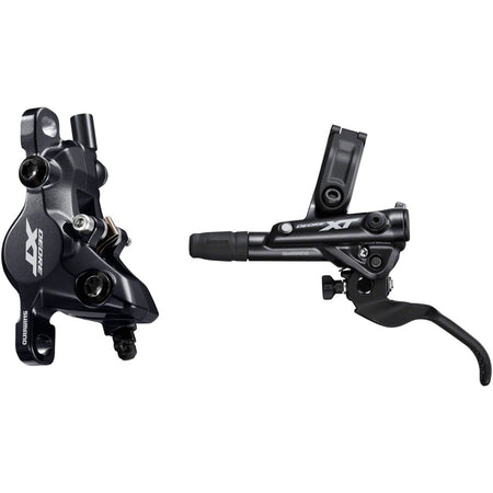 Shimano Deore XT M8100 disc brake with black caliper and rotor, mounted on a mountain bike, showcasing high-performance disc brake system.
