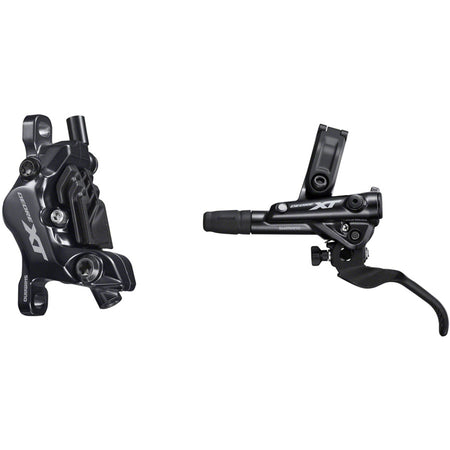Shimano Deore XT M8100 disc brake with black caliper and rotor, mounted on a mountain bike wheel, showcasing high-performance disc braking system.