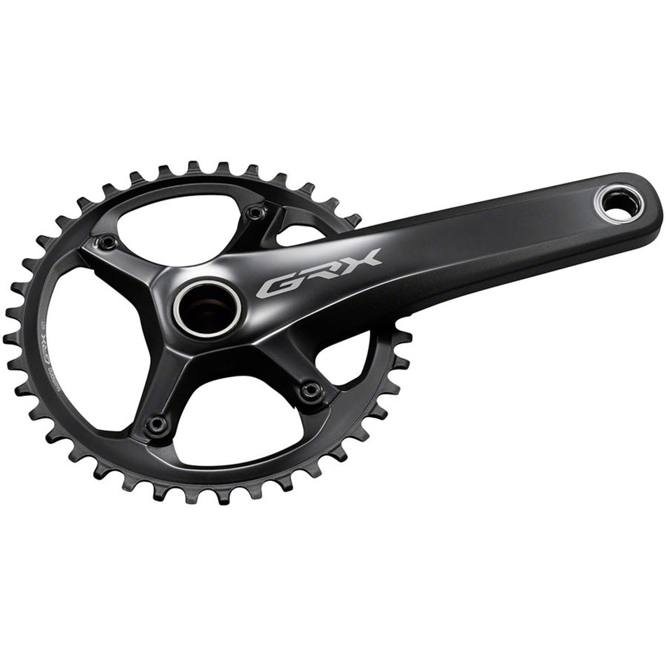 Shimano GRX FC-RX810 crankset with double chainrings and black finish, mounted on a bike drivetrain.