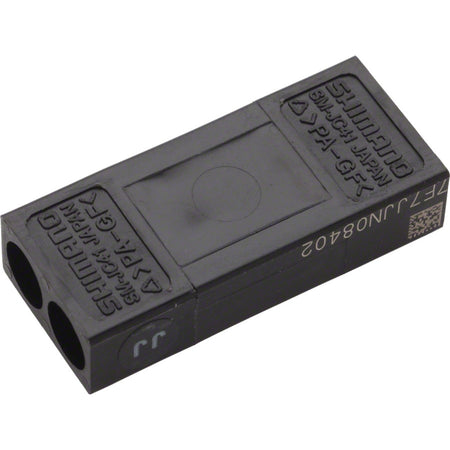 Shimano Di2 frame junction box for electronic shifters, mounted on a bicycle frame, with connection ports visible.