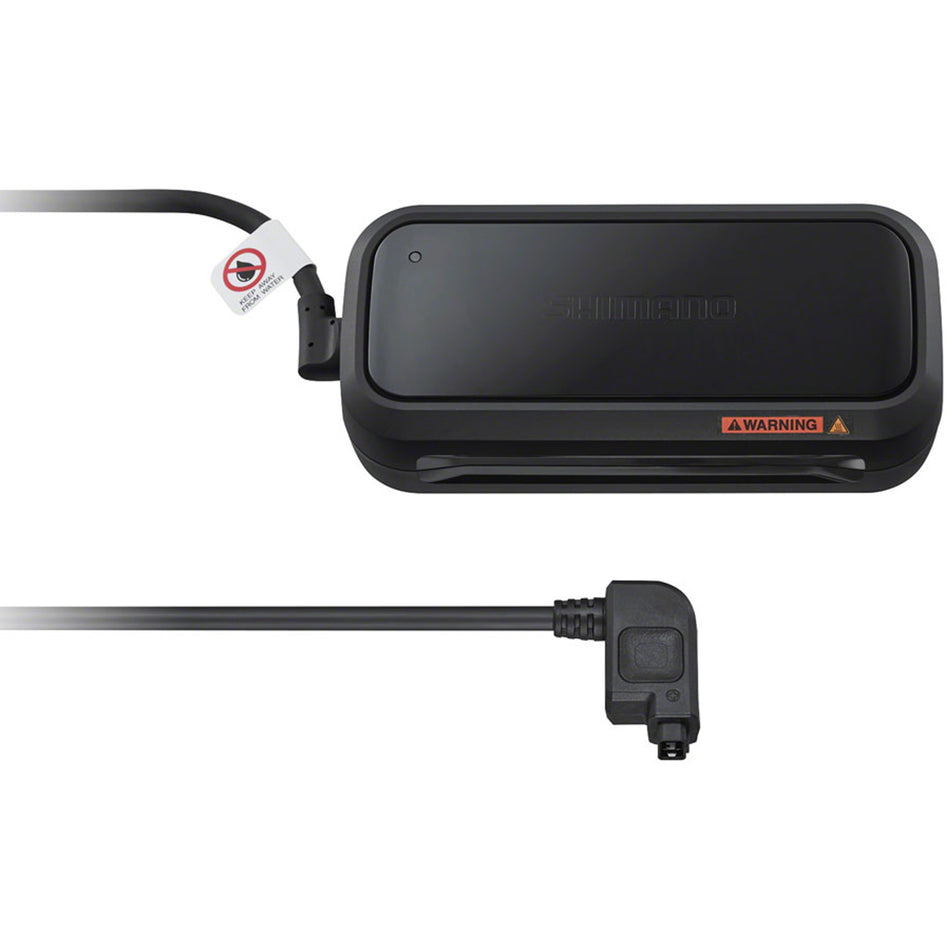 Shimano Steps eBike battery charger connected to a charging port, designed for efficient power recharge of Shimano eBike batteries.