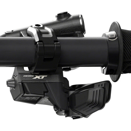 Shimano Deore XT SW-M8150 switch remote control for bike gear shifting, mounted on handlebar with display buttons.