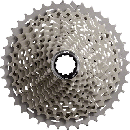 Shimano XT CS-M8000 11-speed cassette with black and silver cogs for mountain bike gearing, mounted on a wheel.
