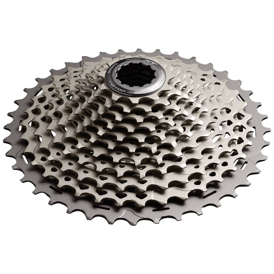 Shimano XT CS-M8000 11-speed cassette with silver cogs for mountain bike gearing, mounted on a bike wheel.