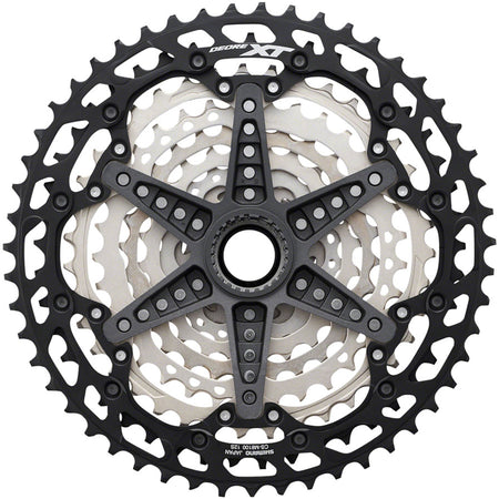 Shimano Deore XT CS-M8100 12-speed bicycle cassette with silver sprockets and black body, designed for mountain bike gearing.