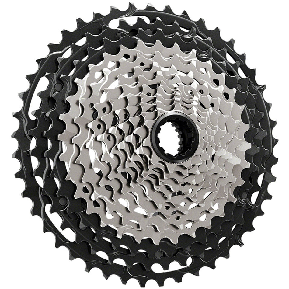 Shimano XTR CS-M9100 12-speed cassette with silver cogs, shown mounted on a bike drivetrain, highlighting high-performance cycling gear.