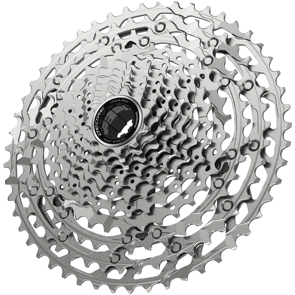 Shimano Deore M5100 cassette with multiple sprockets for mountain biking, shown with detailed metal teeth and black body.