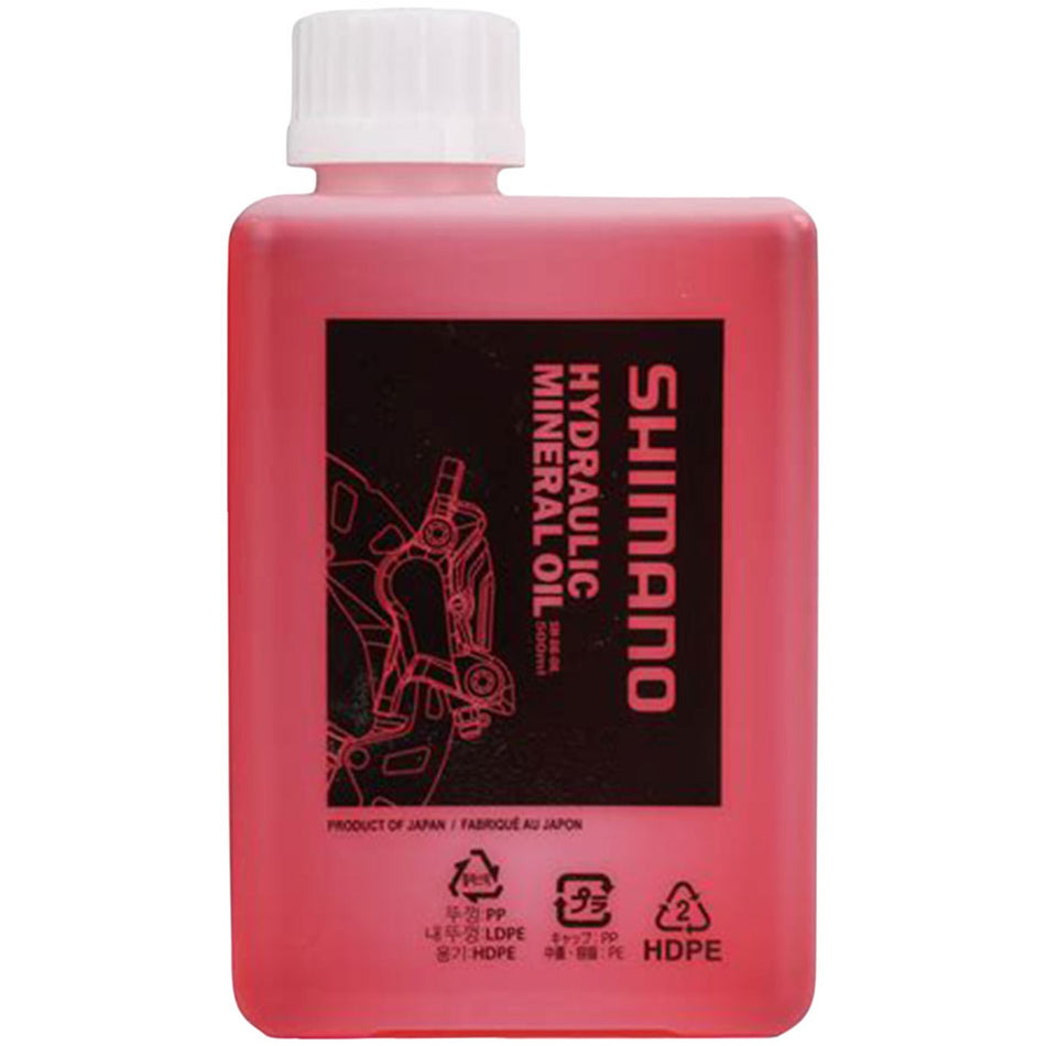 Shimano mineral oil disc brake fluid in a container, used for hydraulic bike brake systems.