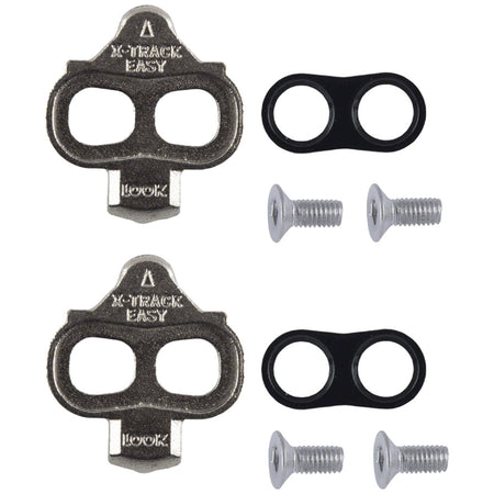 Silver X-track cleats for bicycle pedals, designed by Look Cycle, showing the detailed metal fastening and attachment points.