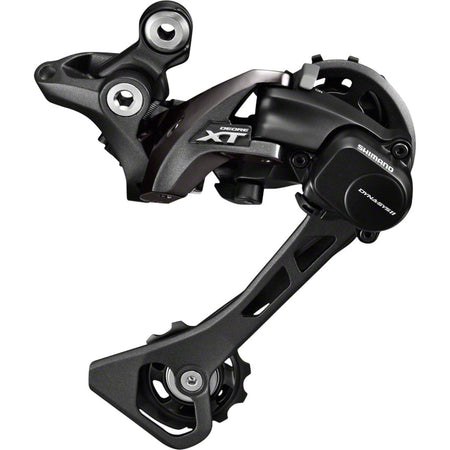 Shimano XT RD-M8000 rear derailleur mounted on bike, showing the durable metal construction and precise gear shifting mechanism.