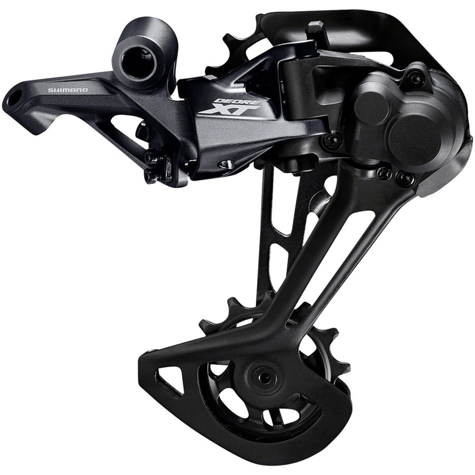 Shimano Deore XT RD-M8100 rear derailleur mounted on bike, showcasing sleek black component with attachment points and gear cage.