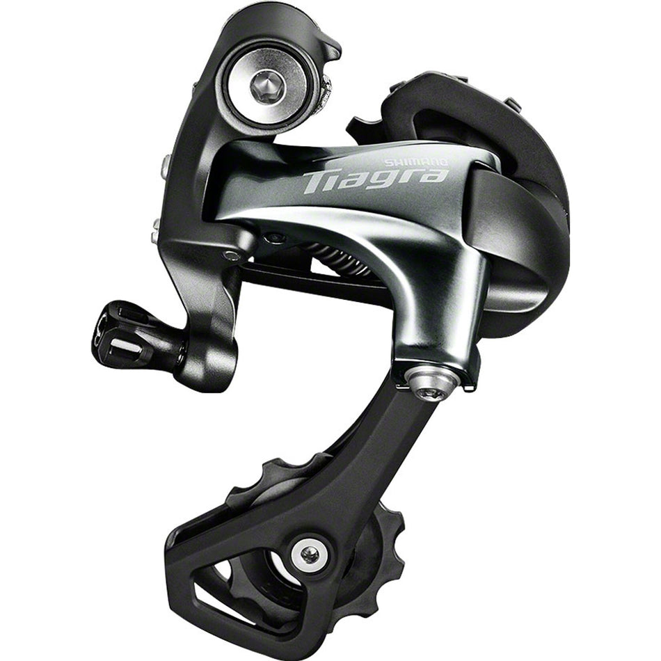 Shimano Tiagra RD-4700 rear derailleur mounted on a bicycle, showcasing precise gear shifting components and sleek design.
