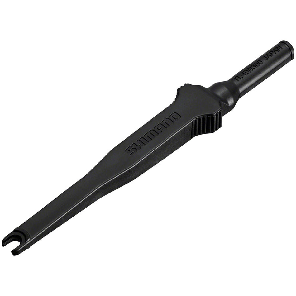 Shimano brake plug tool for connecting and disconnecting EW-SD300 brake wires, shown in use with a black handle and cable.