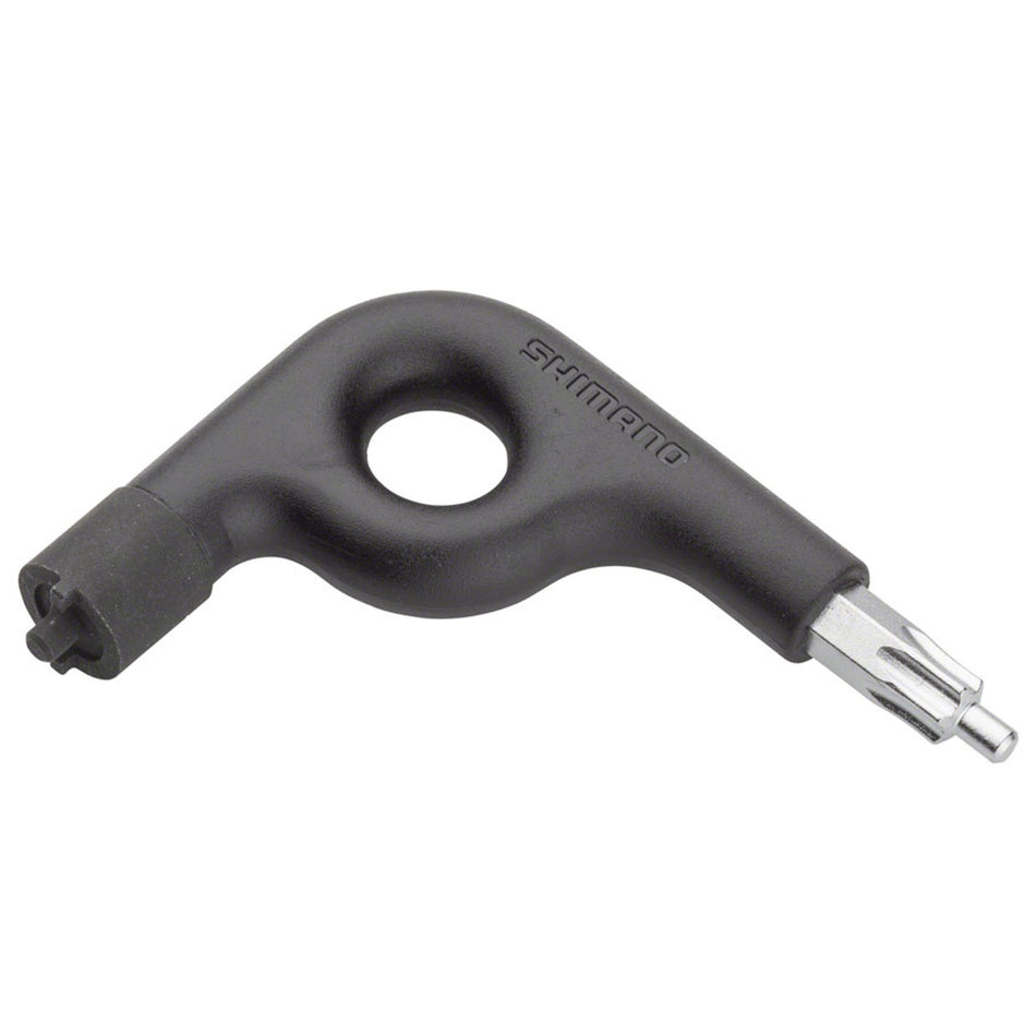 Shimano TL-FC22 Hexalobular Torx wrench lying on a workbench, used for precise bicycle repairs and maintenance.